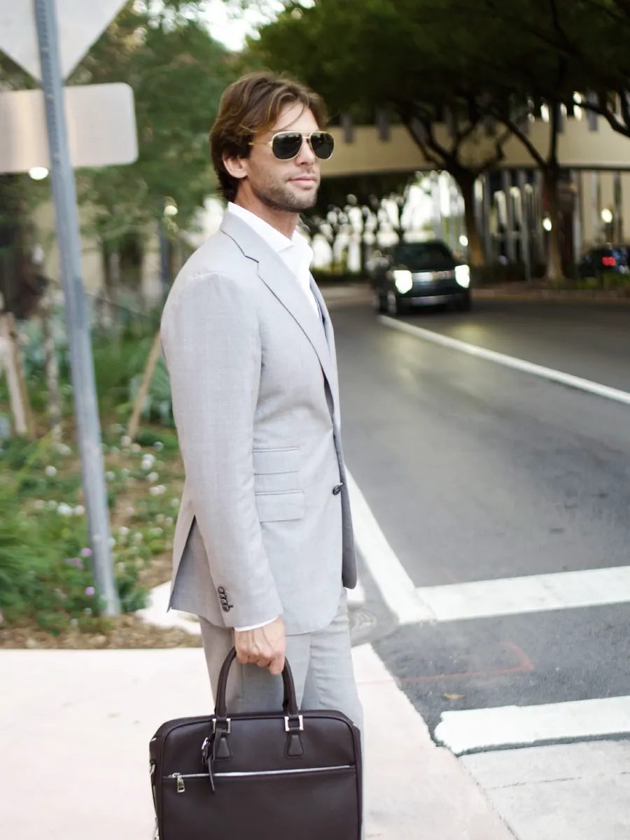 Crossing the street downtown, briefcase in hand