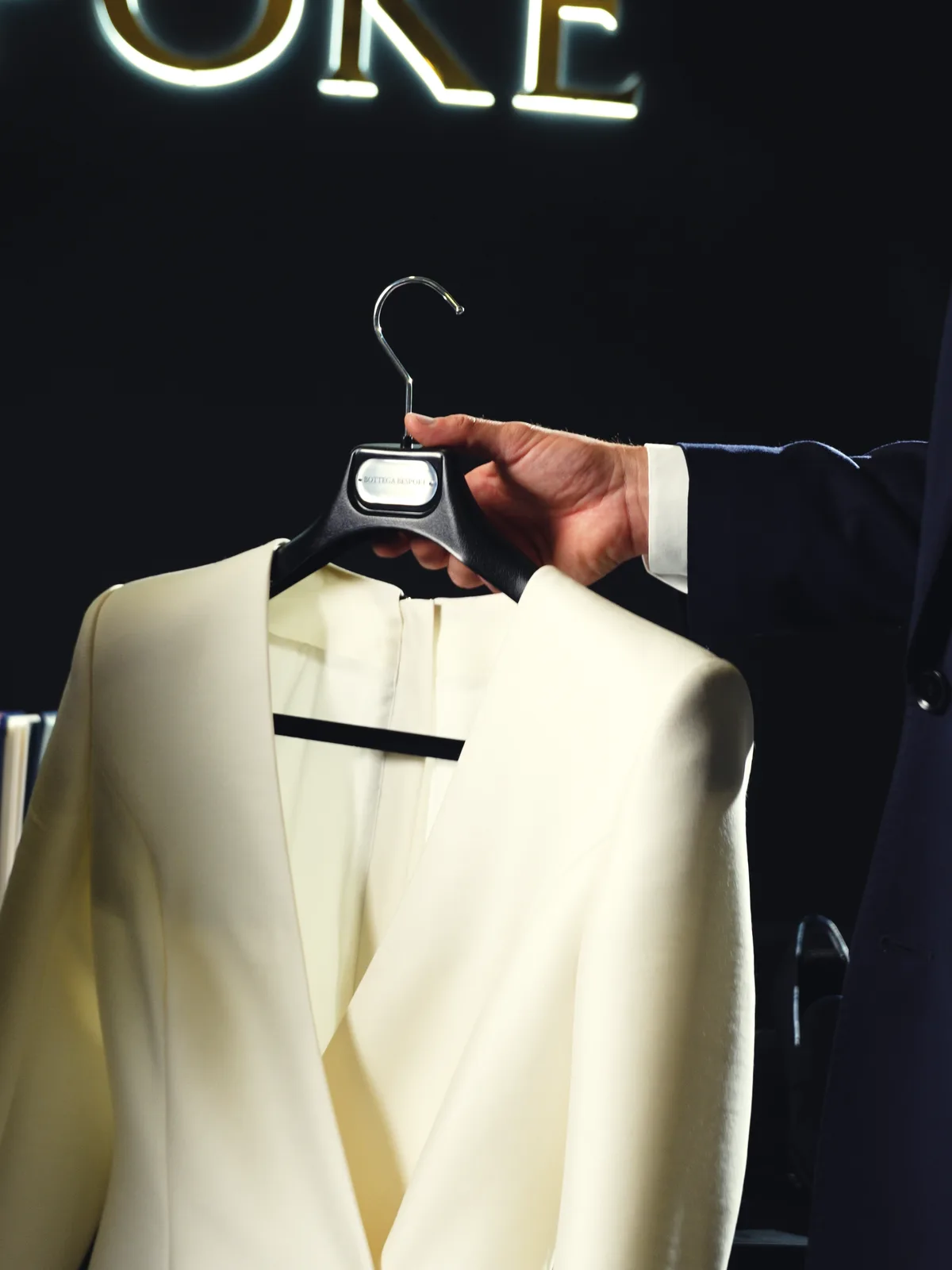 Her jacket, presented on the hanger under the sign